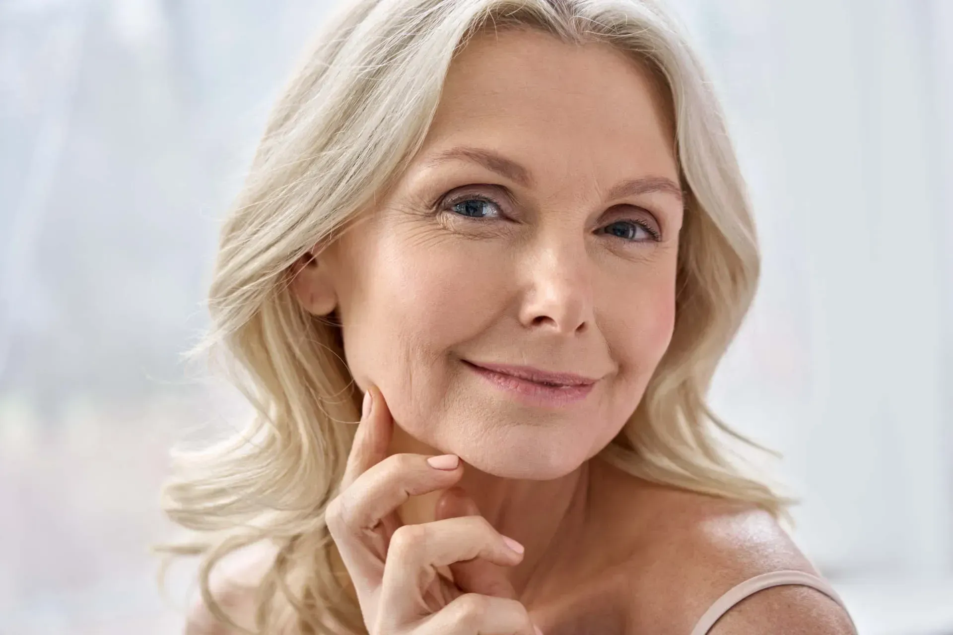 Smiling older woman with long, light-colored hair.