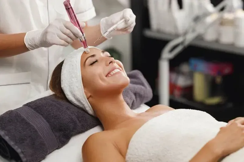 Woman receiving a facial treatment in spa.