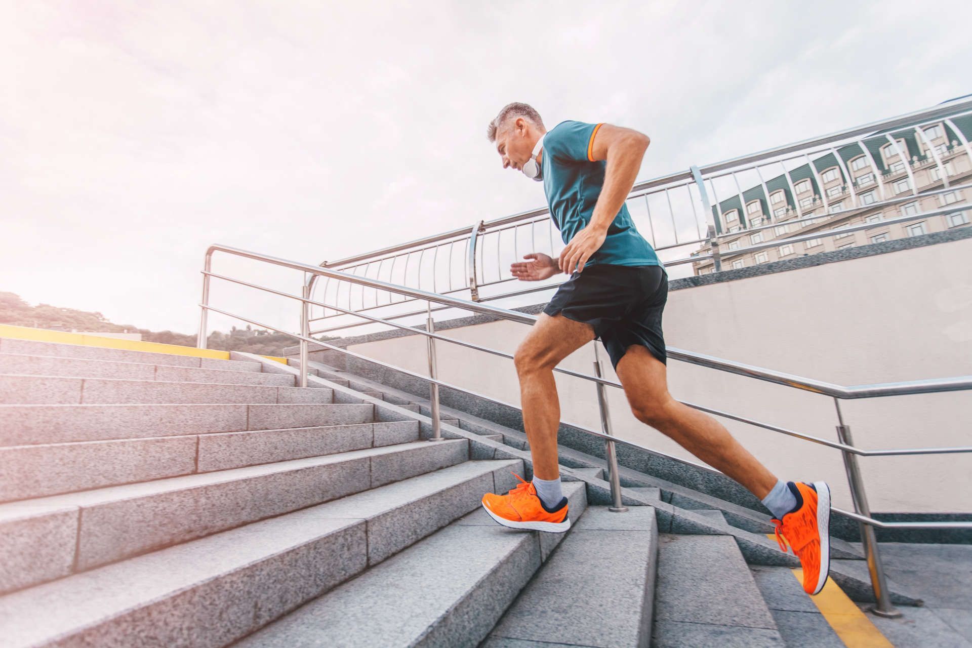 Man running up outdoor stairs. Fitness motivation.